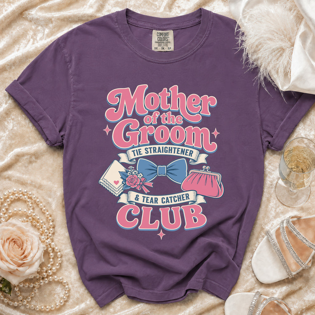 Purple t-shirt with "Mother of the Groom Tie Straightener & Tear Catcher Club" graphic.