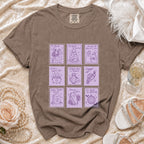 Brown t-shirt featuring a grid of purple postage stamp graphics with spooky wedding illustrations.