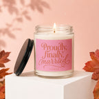 Glass candle with pink label reading "Proudly, finally, married vowed"