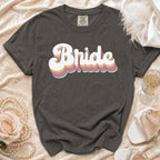Charcoal t-shirt with stacked, retro "Bride" text in pastel colors.