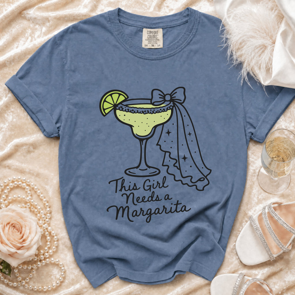 Blue Comfort Colors t-shirt with margarita graphic and text this girl needs a margarita.