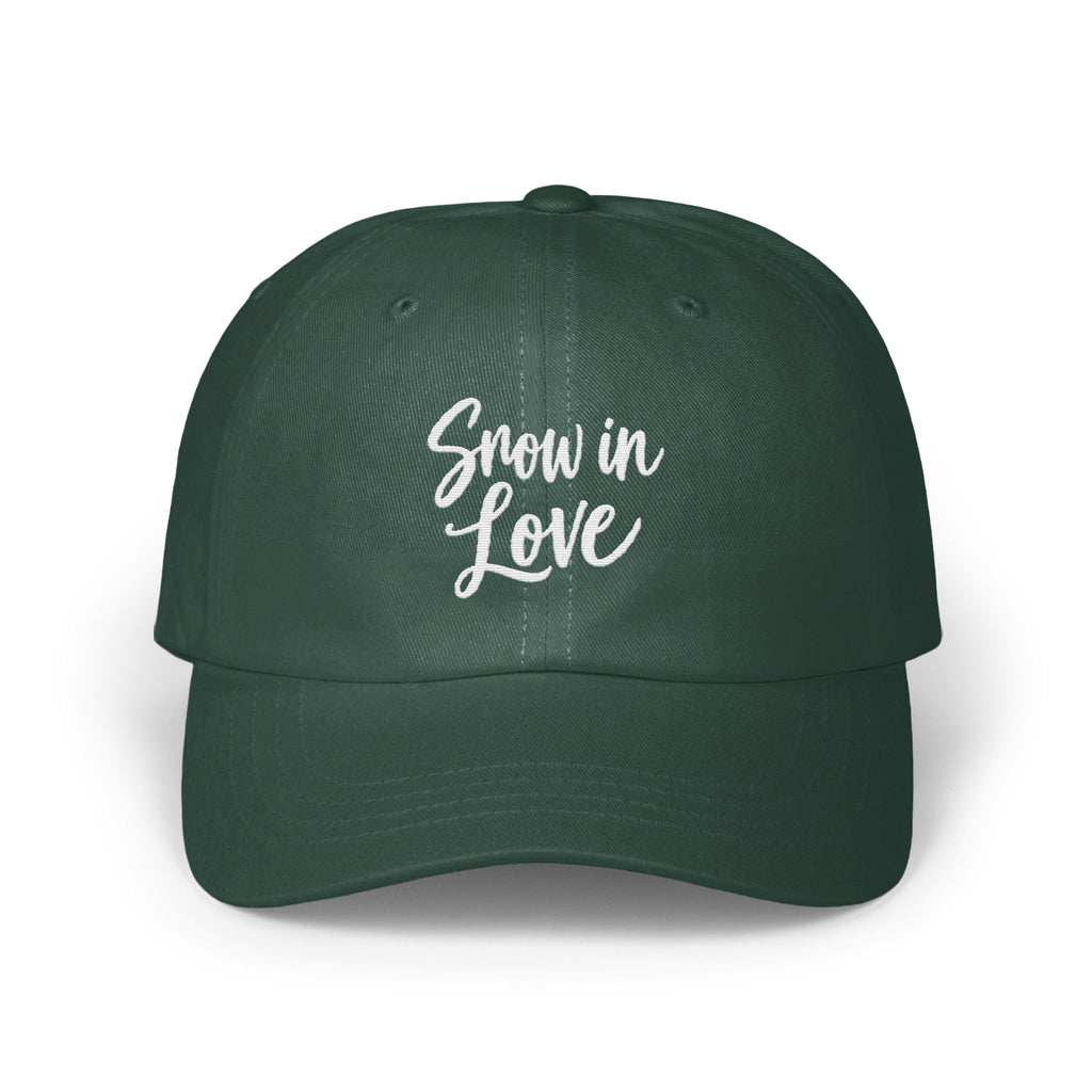 Dark green baseball cap featuring the white embroidered text Snow in Love on the front panel.