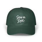 Dark green baseball cap featuring the white embroidered text Snow in Love on the front panel.