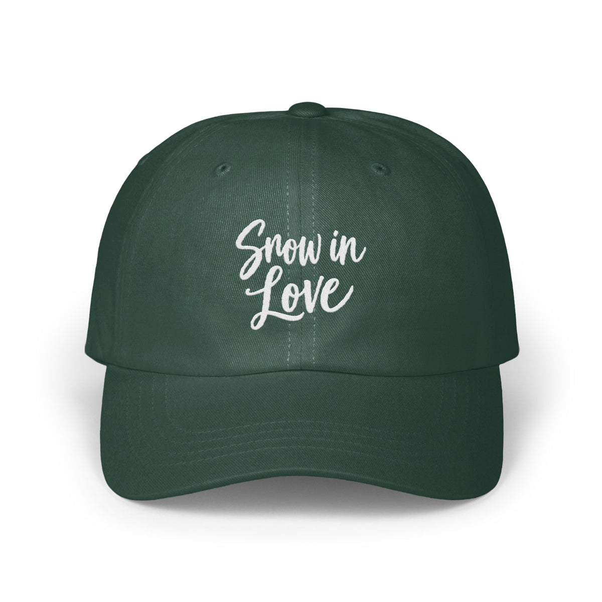 Dark green baseball cap featuring the white embroidered text Snow in Love on the front panel.