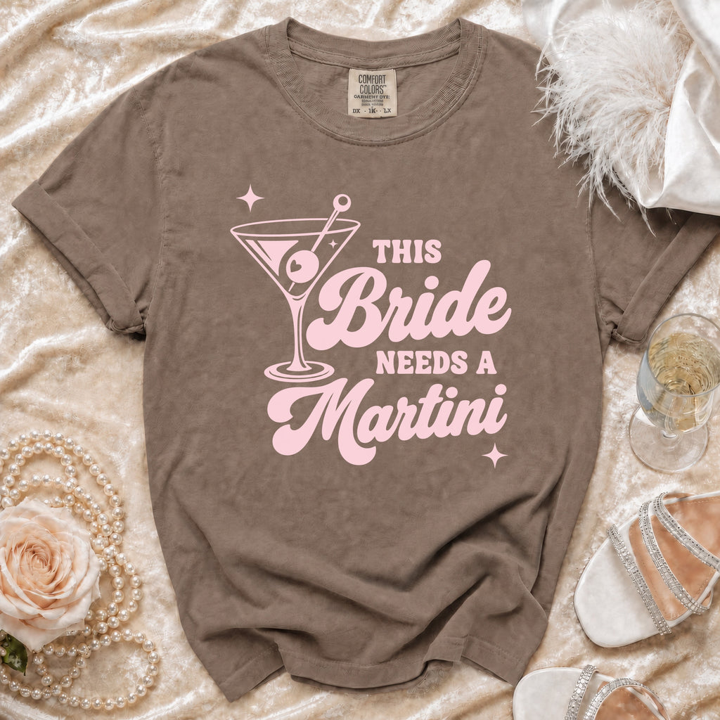 Brown t-shirt with pink "This Bride Needs a Martini" graphic and martini glass.