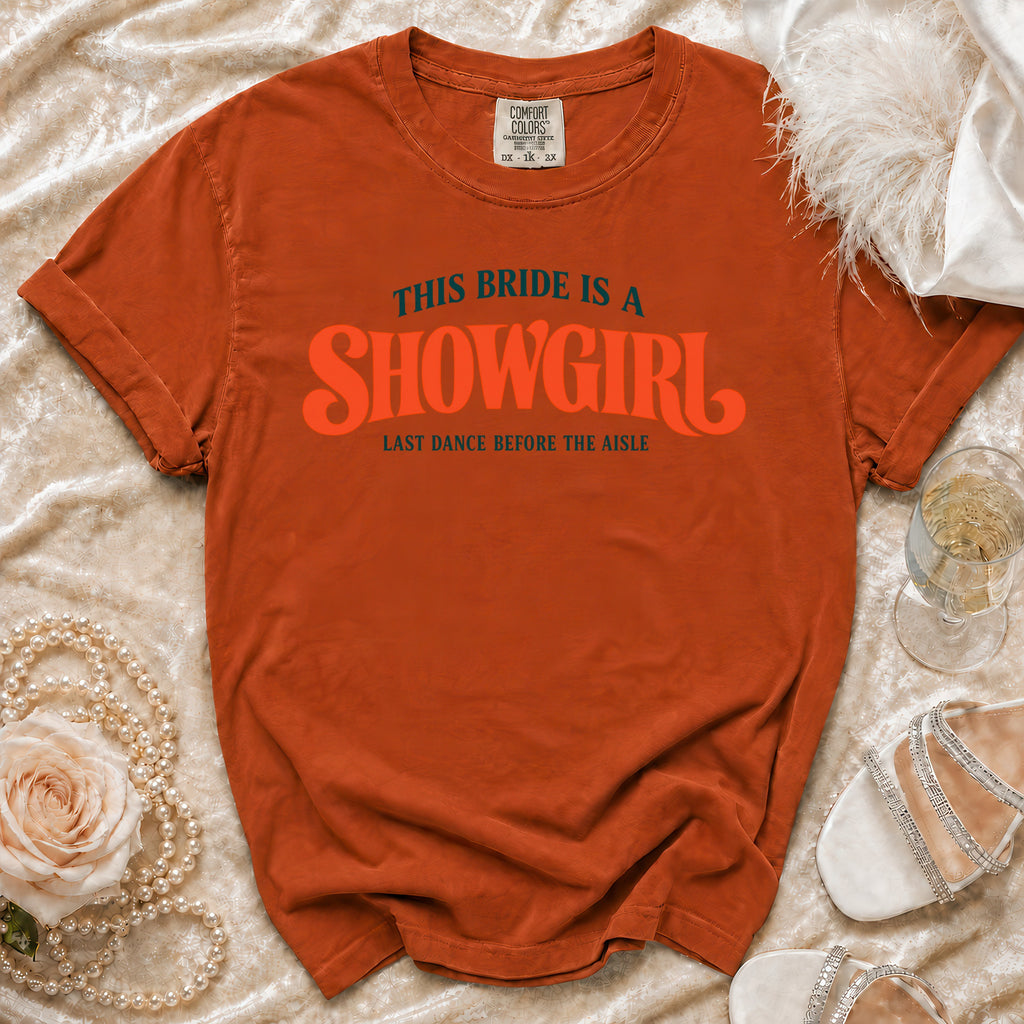 Orange t-shirt with "This Bride is a Showgirl" graphic and wedding accessories.
