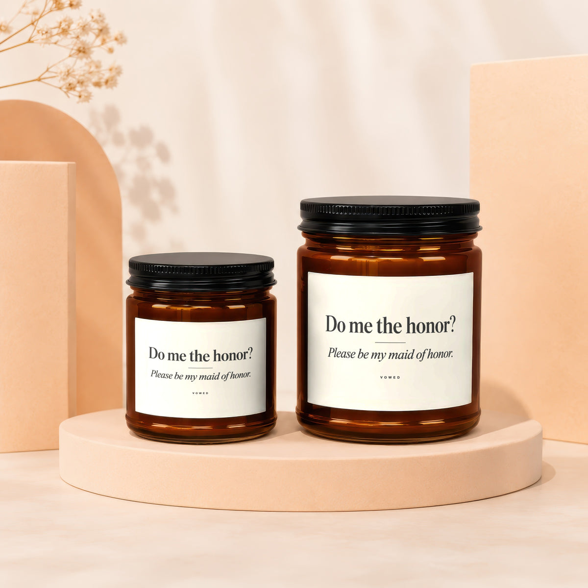 Two amber glass candles with white labels reading "Do me the honor? Please be my maid of honor."