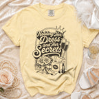 Yellow t-shirt with "Holding Her Dress and Her Secrets" text.
