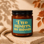 Amber jar candle with teal label reading "Two misters, no missus VOWED".