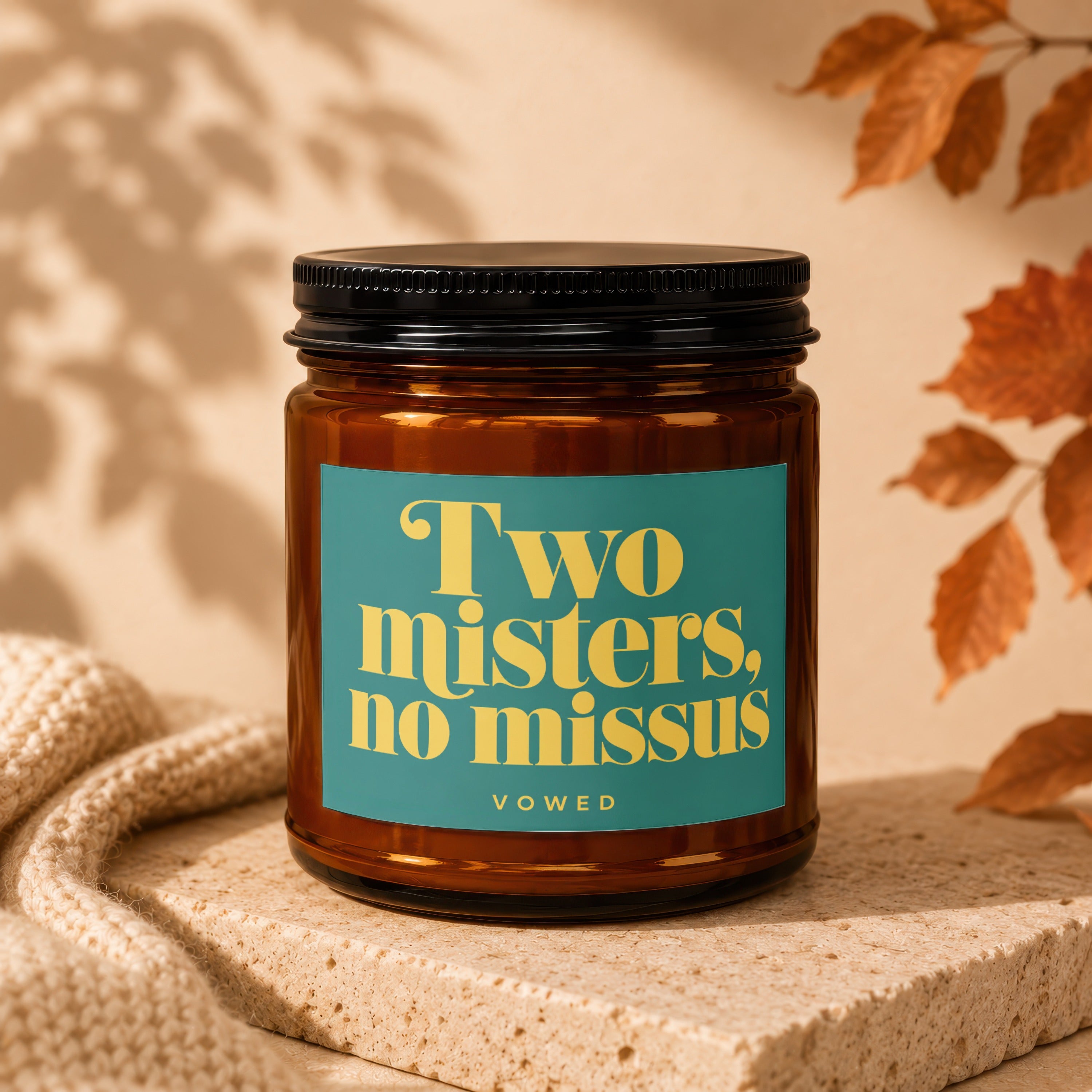 Amber jar candle with teal label reading "Two misters, no missus VOWED".