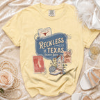 T-shirt with "Reckless in Texas" and disco boot graphic.