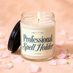 Glass candle with "Professional Spell Holder" text surrounded by pink petals.