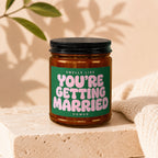 Candle with green label reading "Smells Like You're Getting Married."