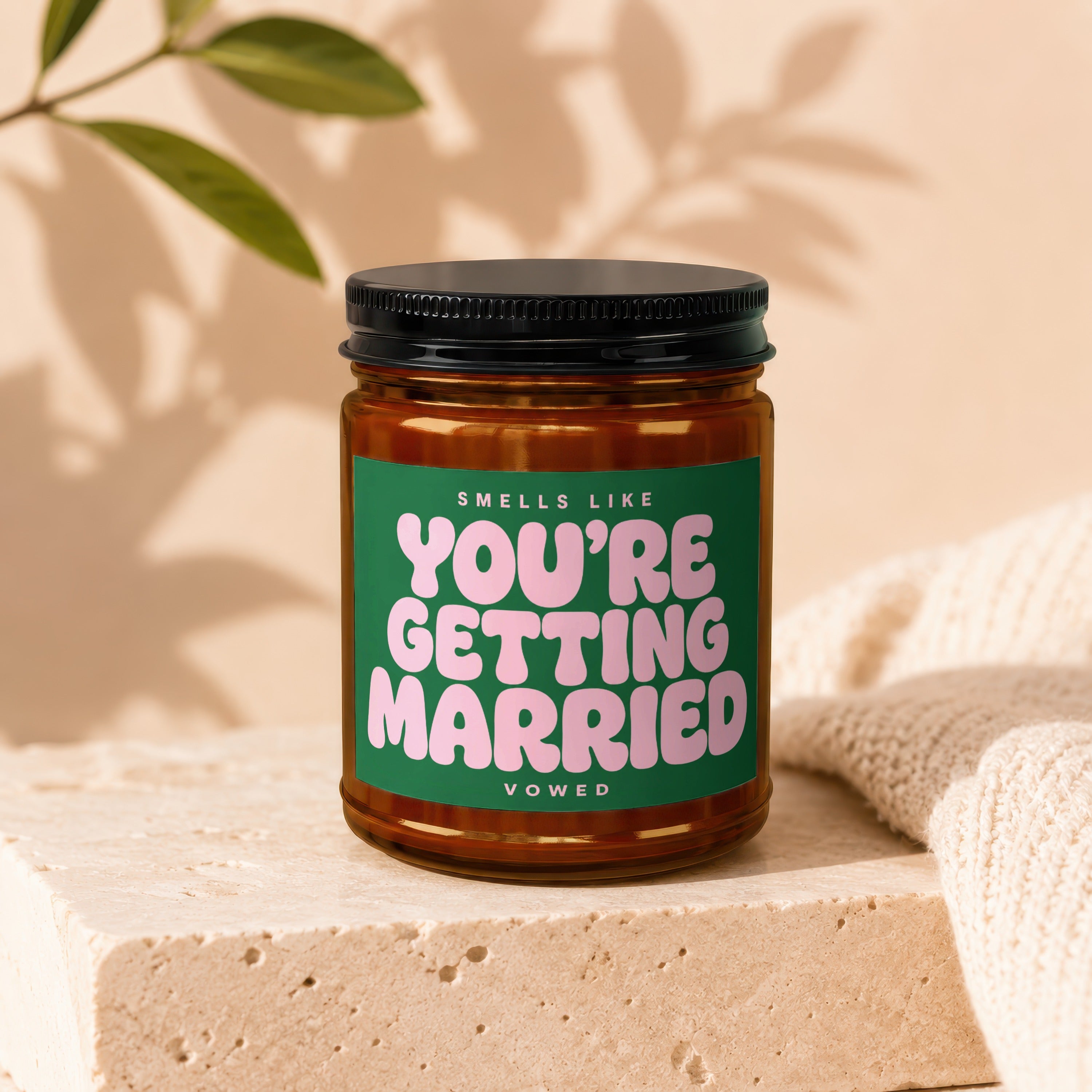 Candle with green label reading "Smells Like You're Getting Married."