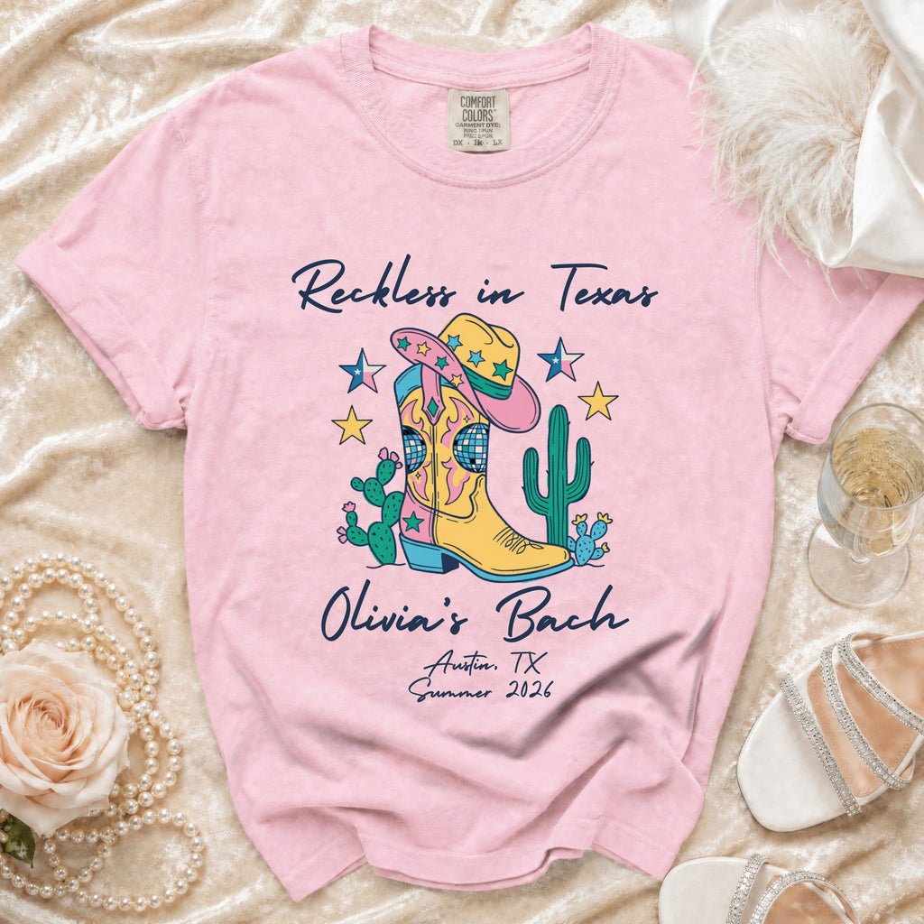 Pink t-shirt with "Reckless in Texas" and "Olivia's Bach" designs.