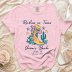 Pink t-shirt with "Reckless in Texas" and "Olivia's Bach" designs.