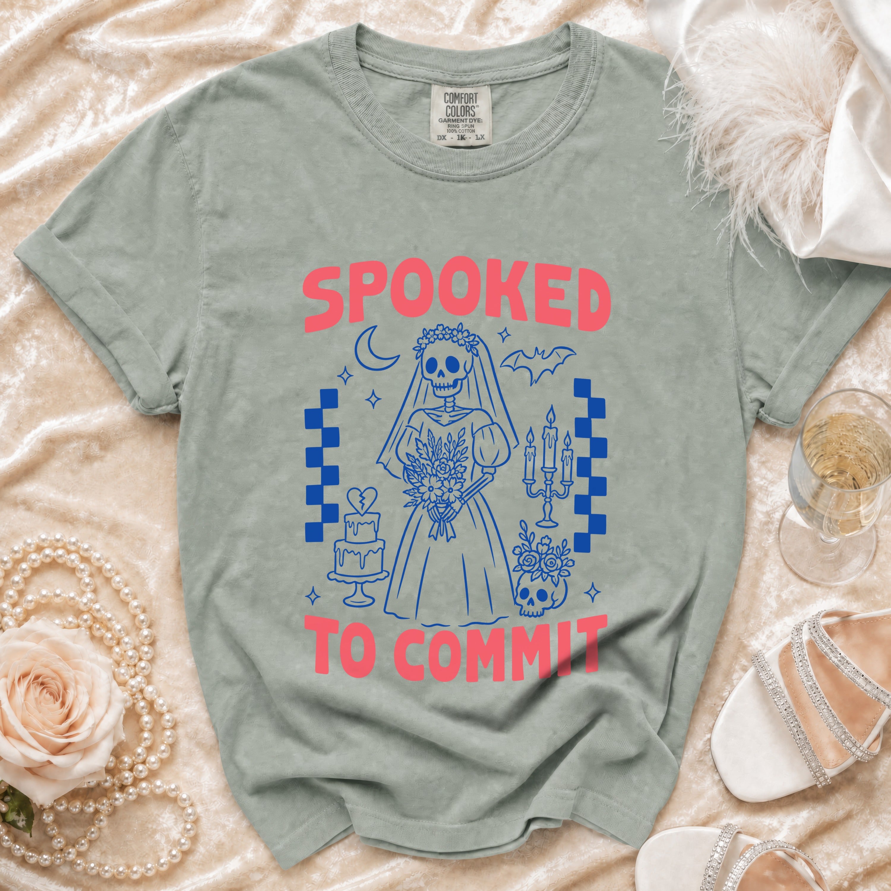 "Spooked to Commit" text with skeleton bride graphic on a muted green t-shirt.