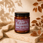Brown candle with "Two husbands, one to-do list" text on label.