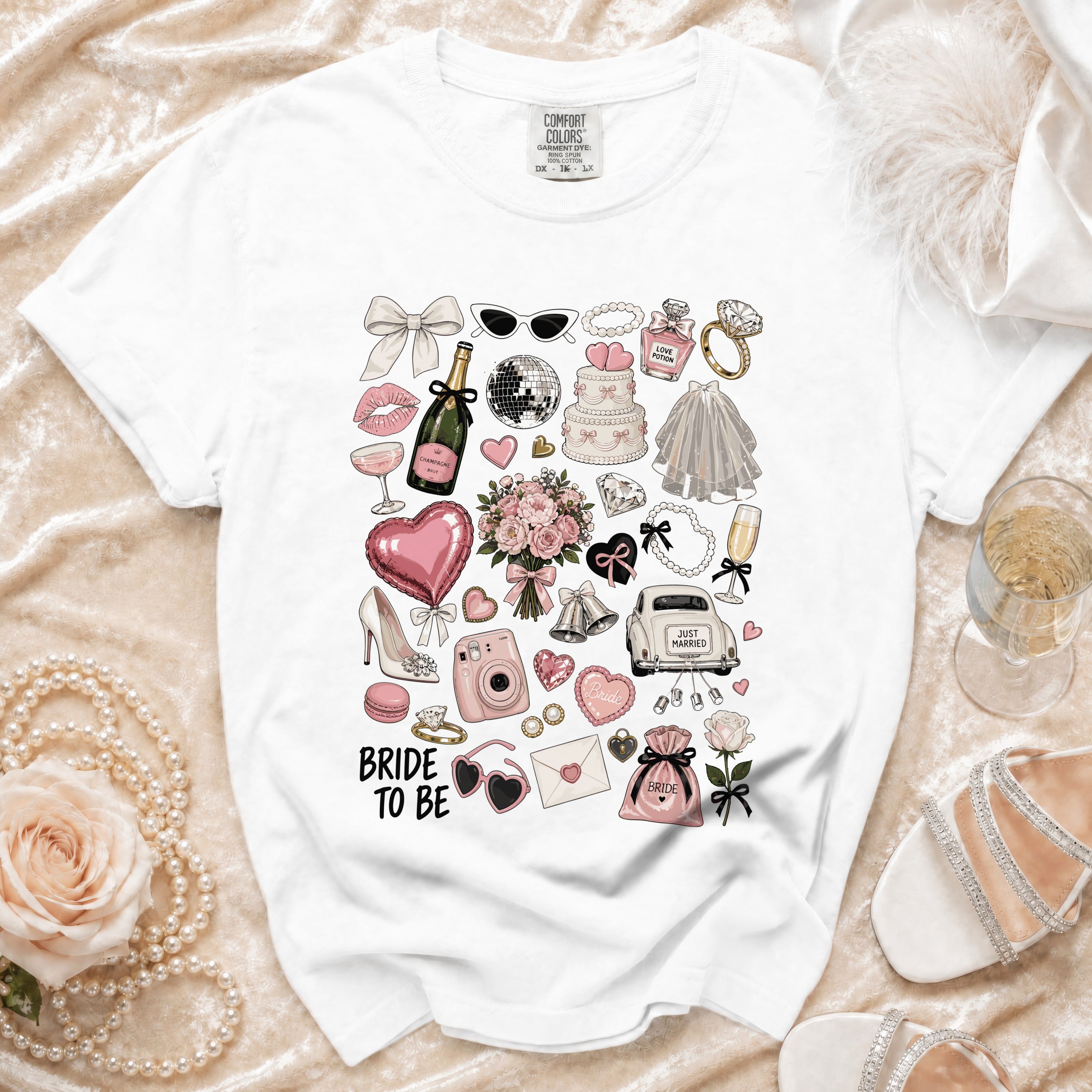 White t-shirt with "BRIDE TO BE" and wedding-themed illustrations.
