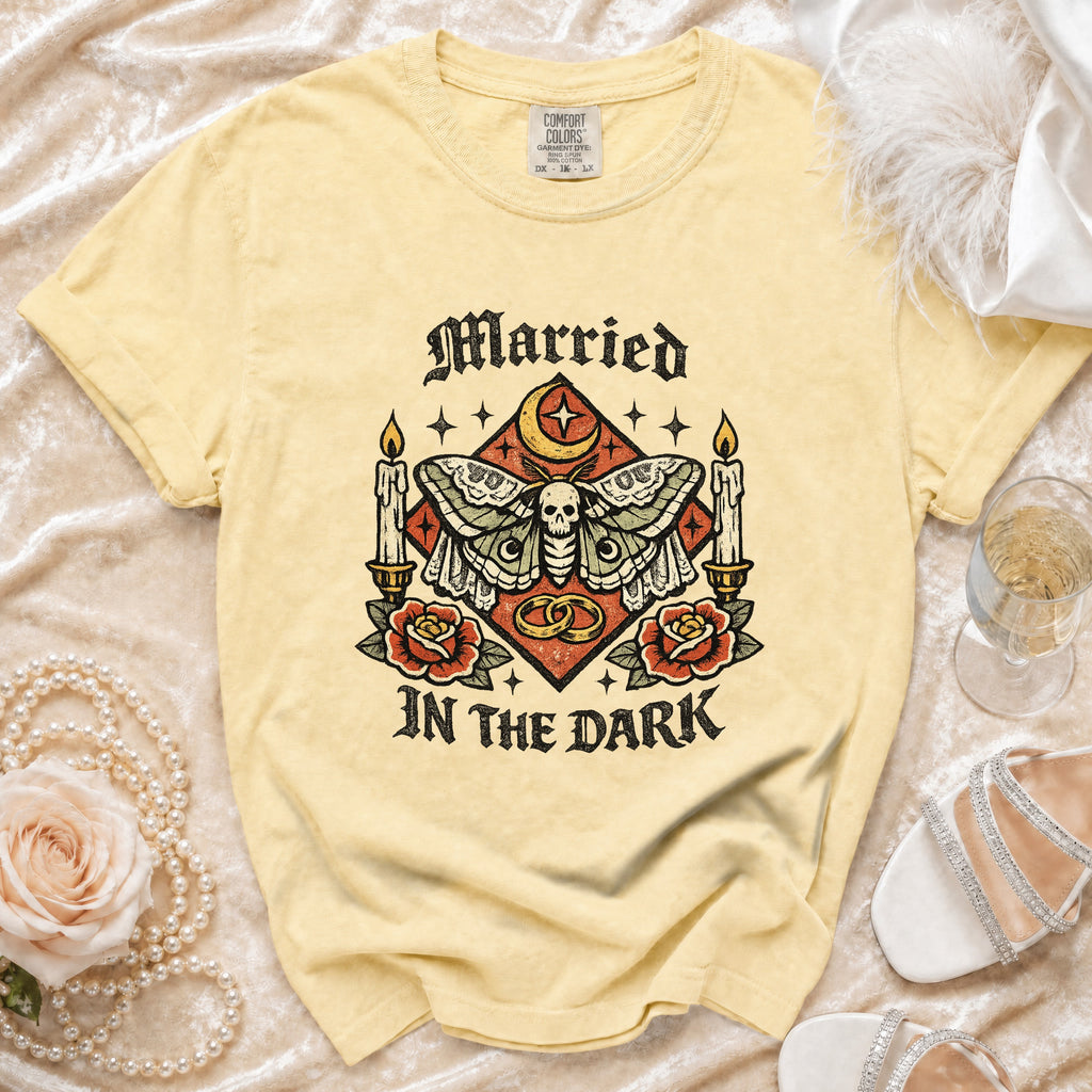 Yellow t-shirt with "Married In The Dark" graphic featuring a moth, skull, candles, and rings.