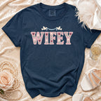Navy Comfort Colors shirt with "WIFEY" in floral lettering and doves.