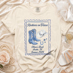Cream t-shirt with "Reckless in Texas" stamp design, cowboy boots, hat, and horseshoe.