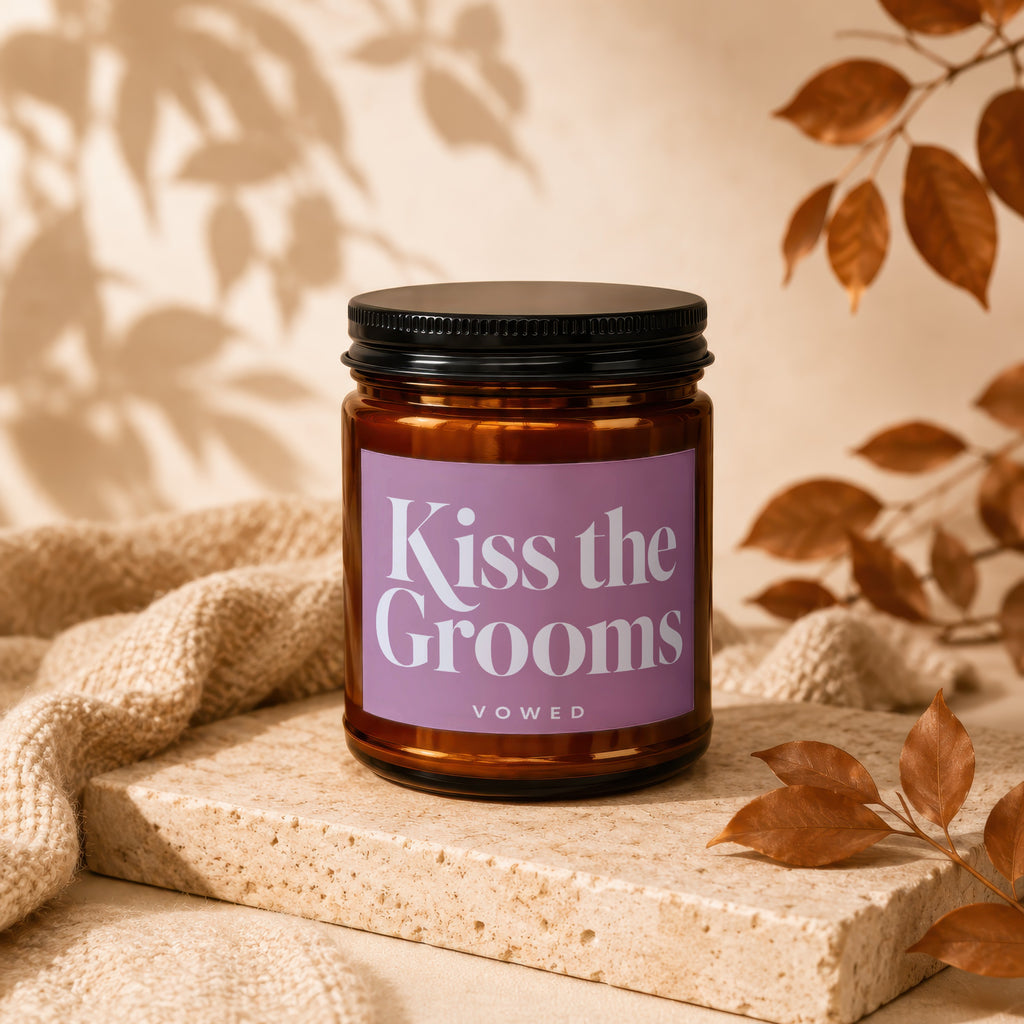 Amber jar candle with lavender label reading "Kiss the Grooms vowed".