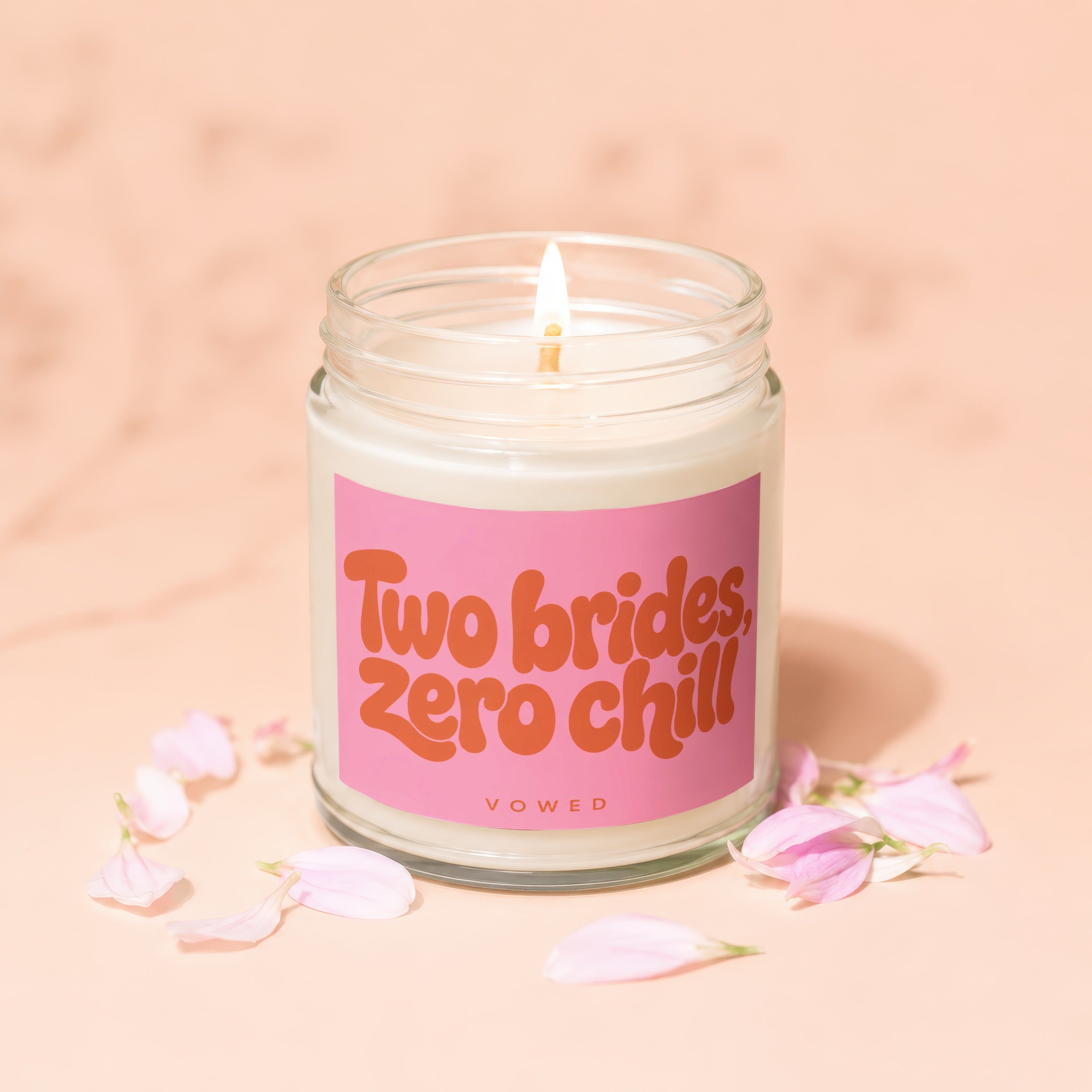 Candle with pink label reading "Two brides, zero chill" and "VOWED".