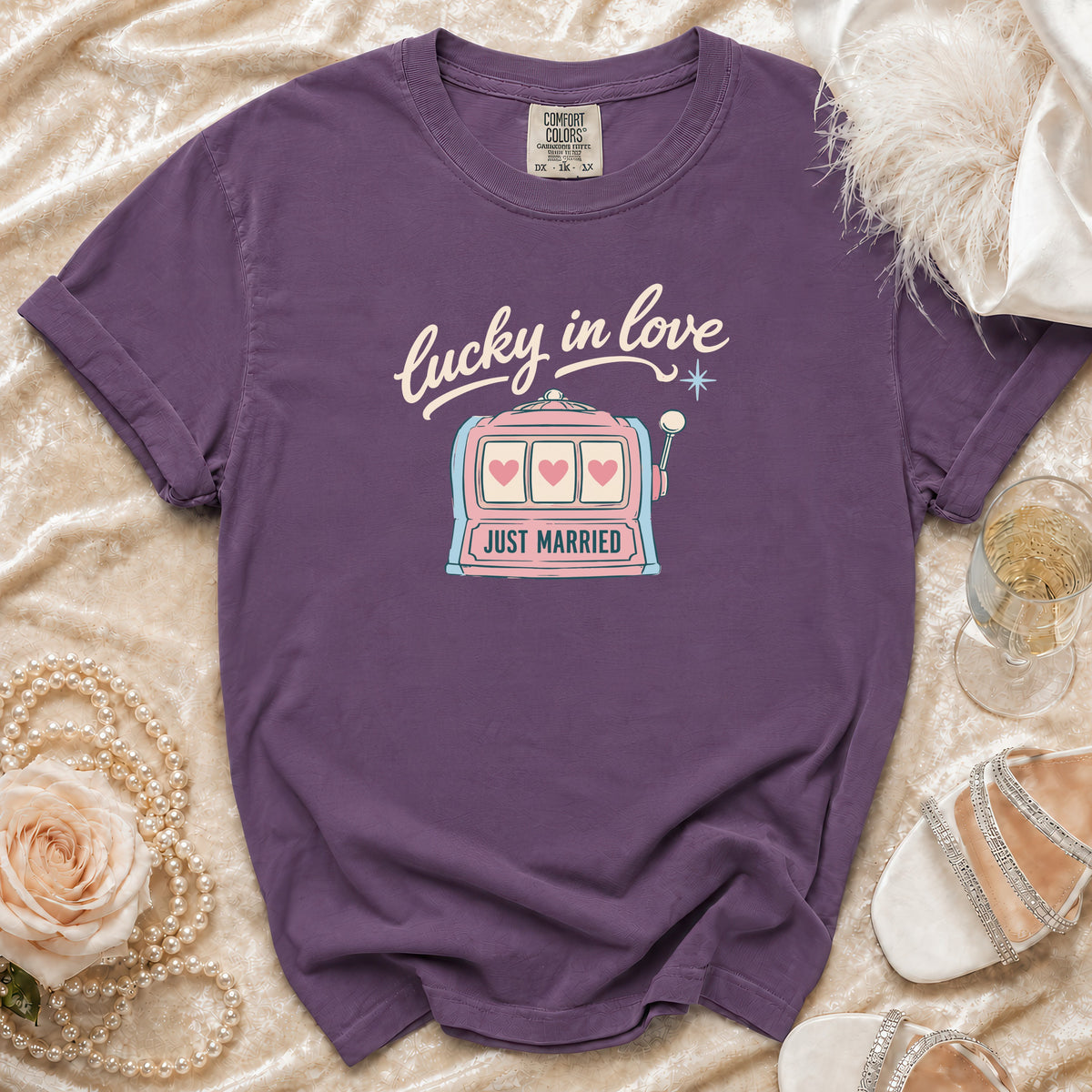 Purple t-shirt with "lucky in love" text and "Just Married" slot machine graphic.