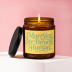 Amber jar candle with lit wick and black lid, reads "Marrying My Favorite Human VOWED".