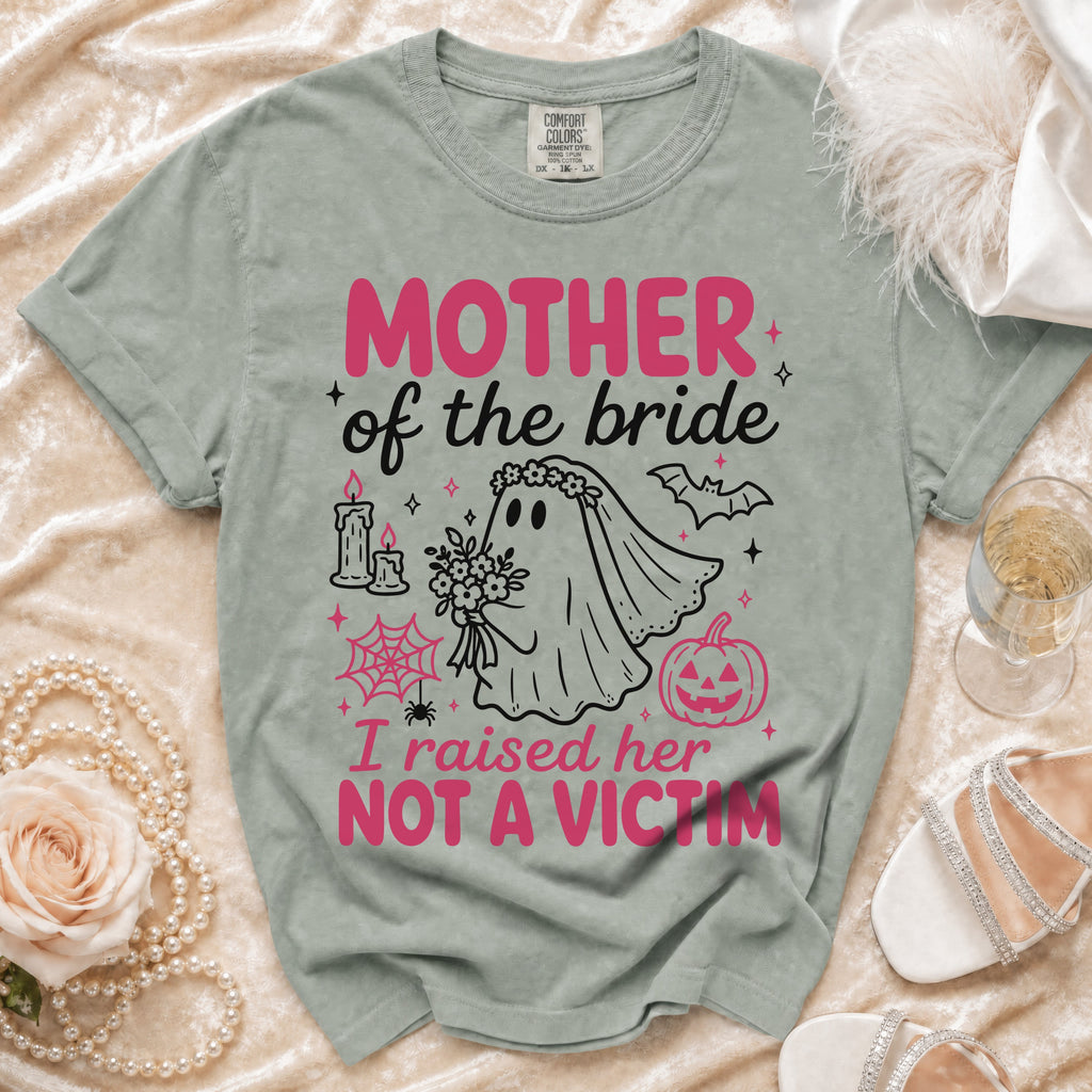 Green t-shirt with "MOTHER of the bride I raised her NOT A VICTIM" graphic.