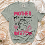 Green t-shirt with "MOTHER of the bride I raised her NOT A VICTIM" graphic.