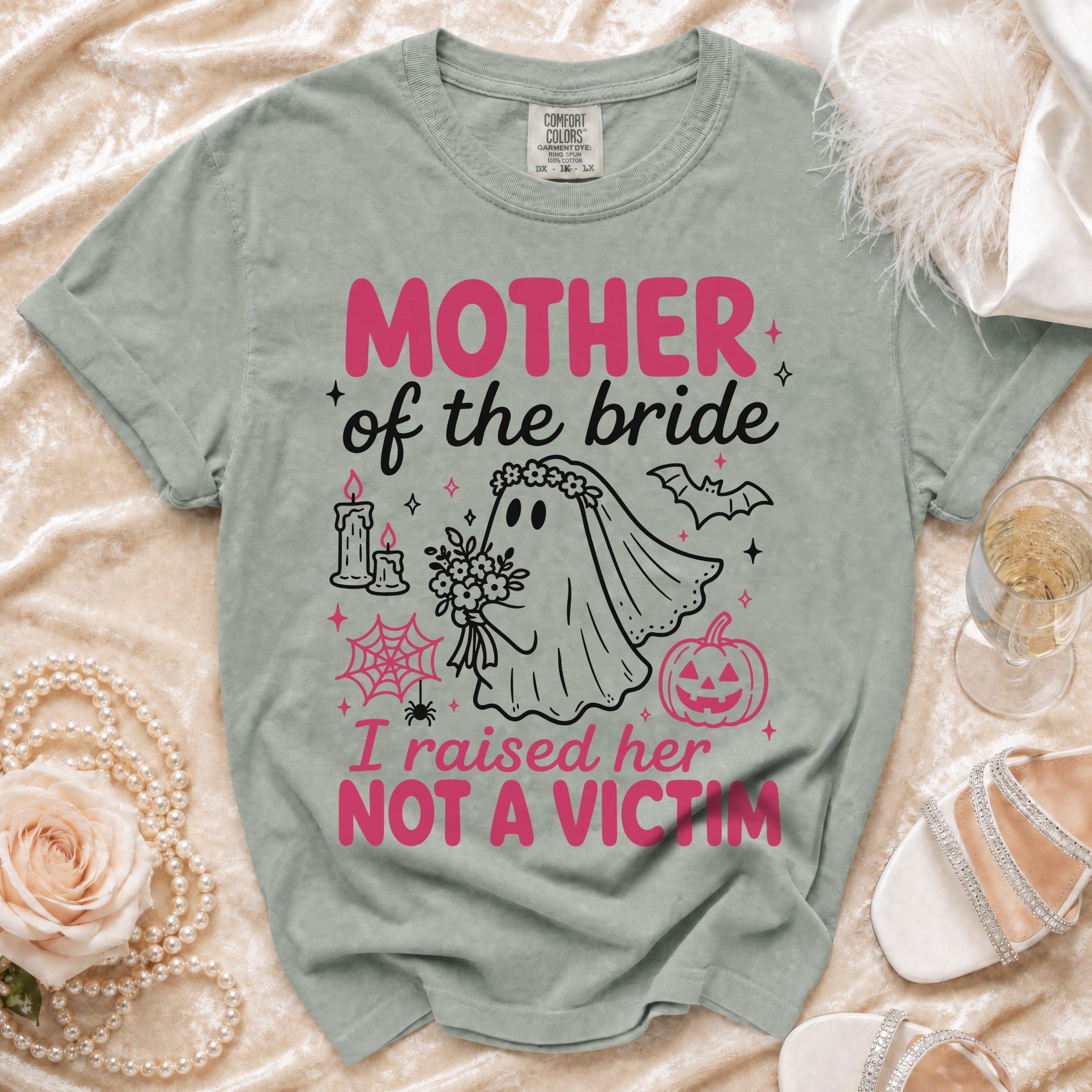 Green t-shirt with "MOTHER of the bride I raised her NOT A VICTIM" graphic.