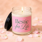 Lit glass candle with pink label saying "Bestie for Life".