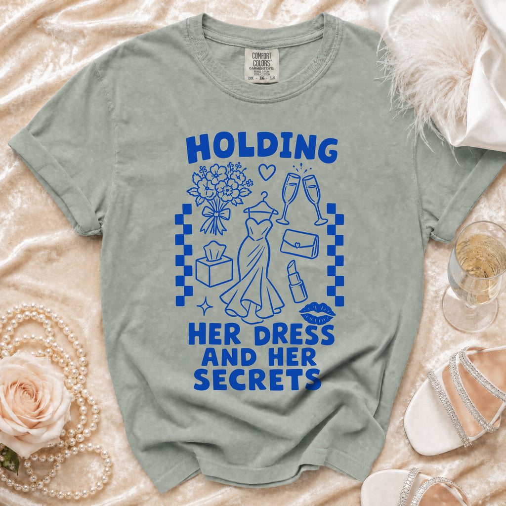 Green t-shirt with blue graphic of "Holding Her Dress And Her Secrets".