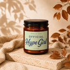 Amber jar candle labeled "Smells Like Official Hype Girl" by Vowed.