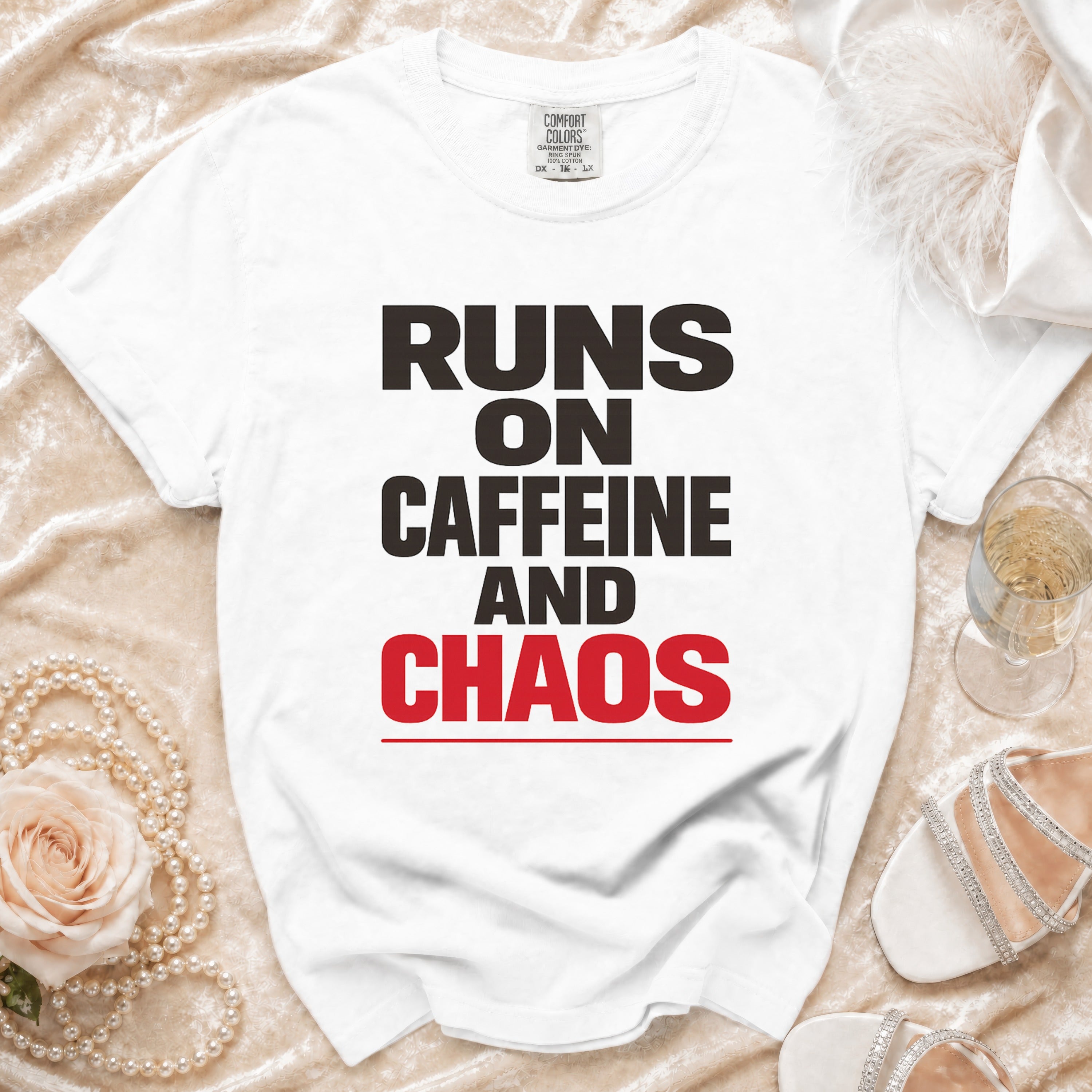 White t-shirt with "RUNS ON CAFFEINE AND CHAOS" text.