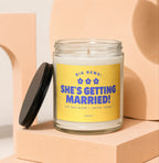 Glass candle with yellow label reading "BIG NEWS: SHE'S GETTING MARRIED!".
