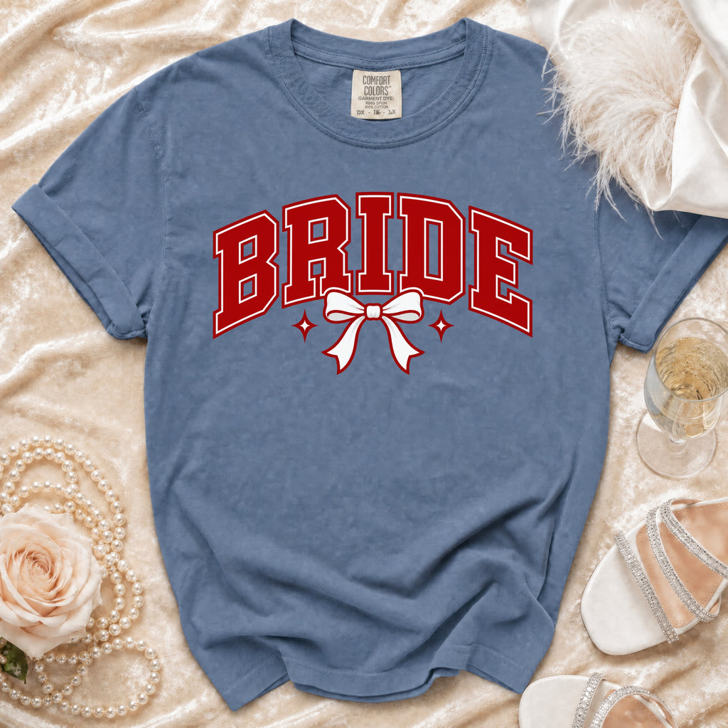 Blue t-shirt with "BRIDE" in red lettering and a white bow graphic.
