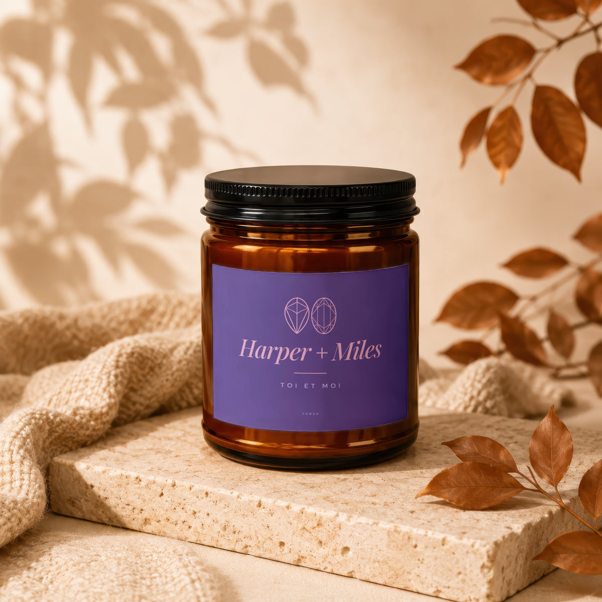 Harper + Miles "Toi et Moi" scented candle in amber glass with purple label.