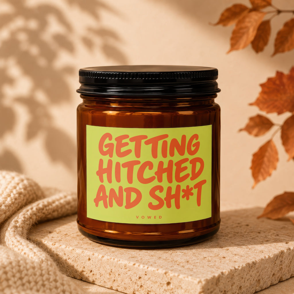 Amber candle with a label reading "Getting Hitched and Sh*t" by Vowed.