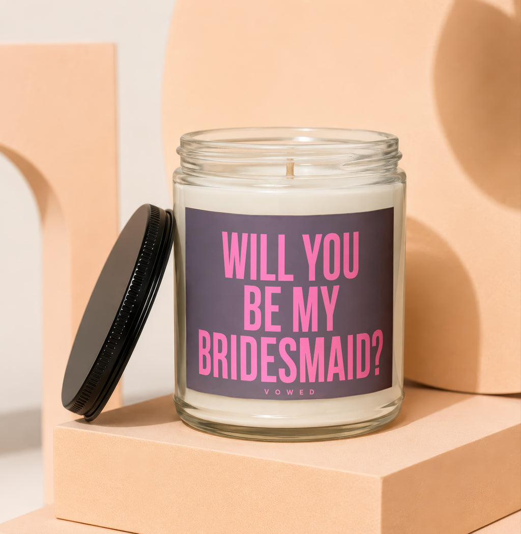 Candle with text "WILL YOU BE MY BRIDESMAID?" in a glass jar with black lid.
