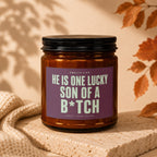 Brown candle with "He is one lucky son of a b*tch" text on label.