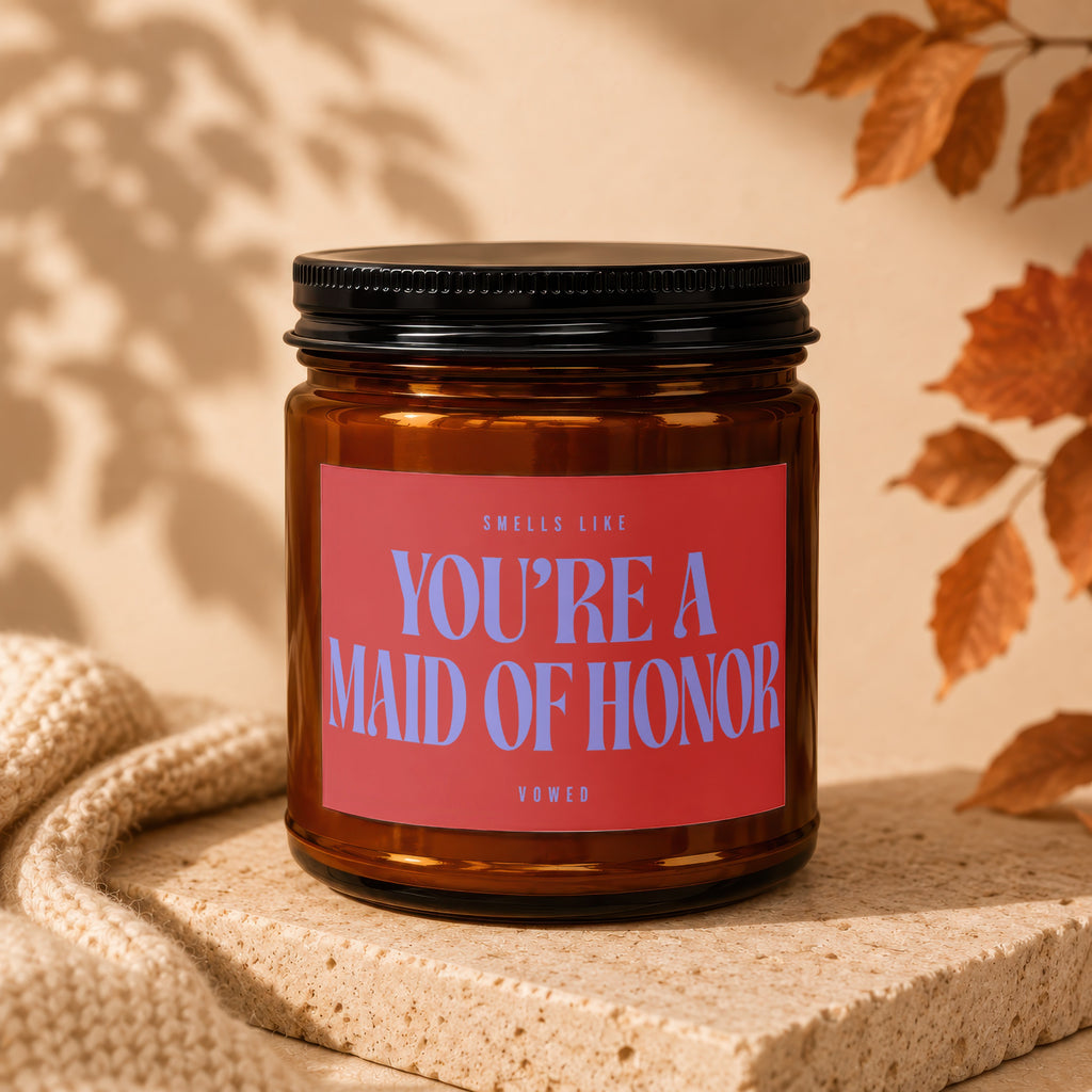 Brown glass candle with red label reading "You're a Maid of Honor".