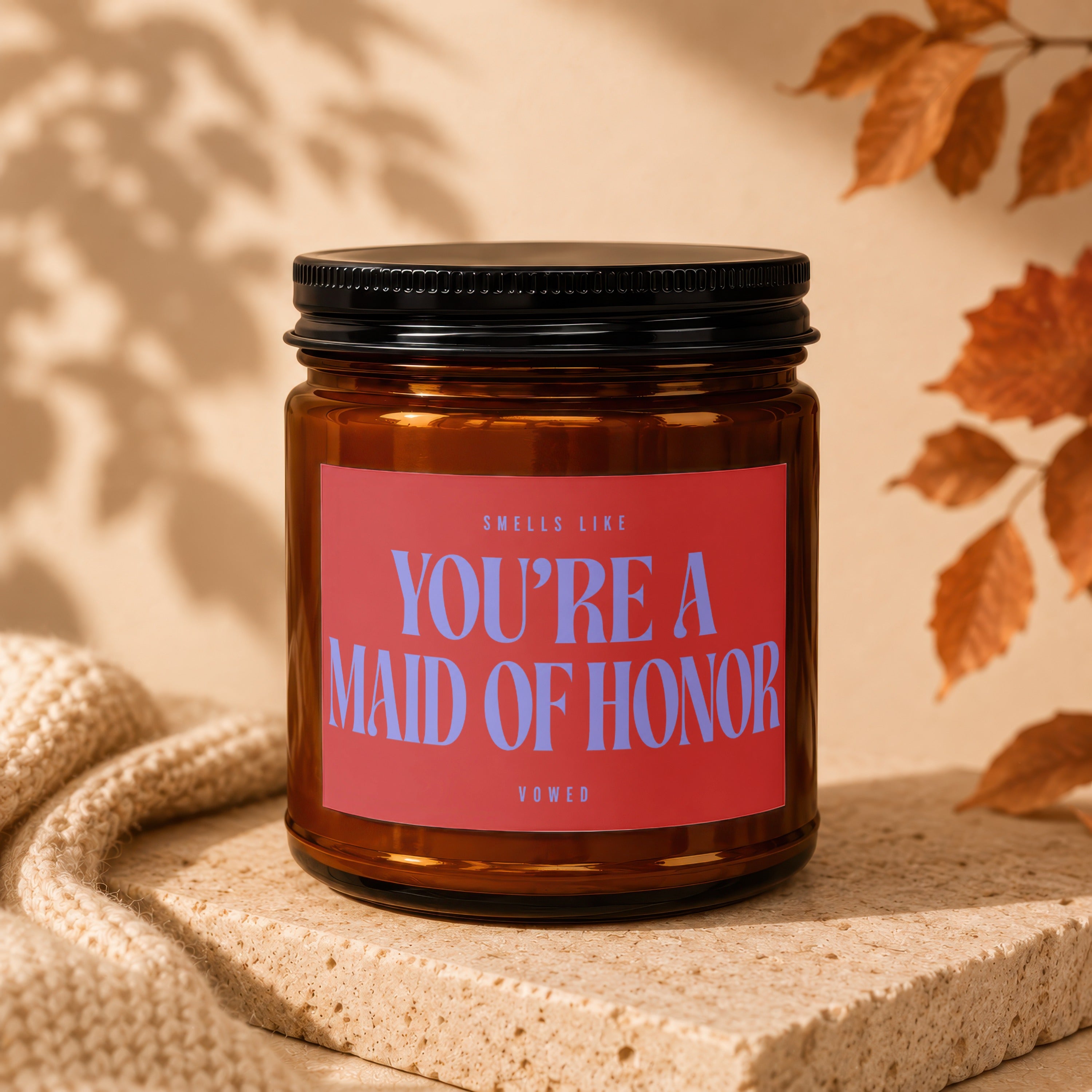 Brown glass candle with red label reading "You're a Maid of Honor".
