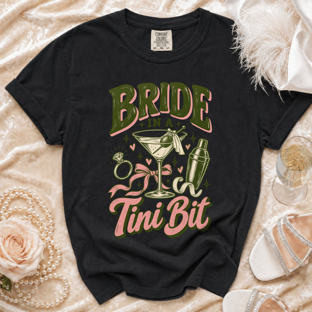 Black t-shirt with "Bride in a Martini Bit" text and cocktail graphic.