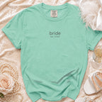 Mint Comfort Colors t-shirt with "bride est. 2026" text, flat lay.