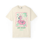 Cream t-shirt with flamingo float, cocktail, and palm leaves.