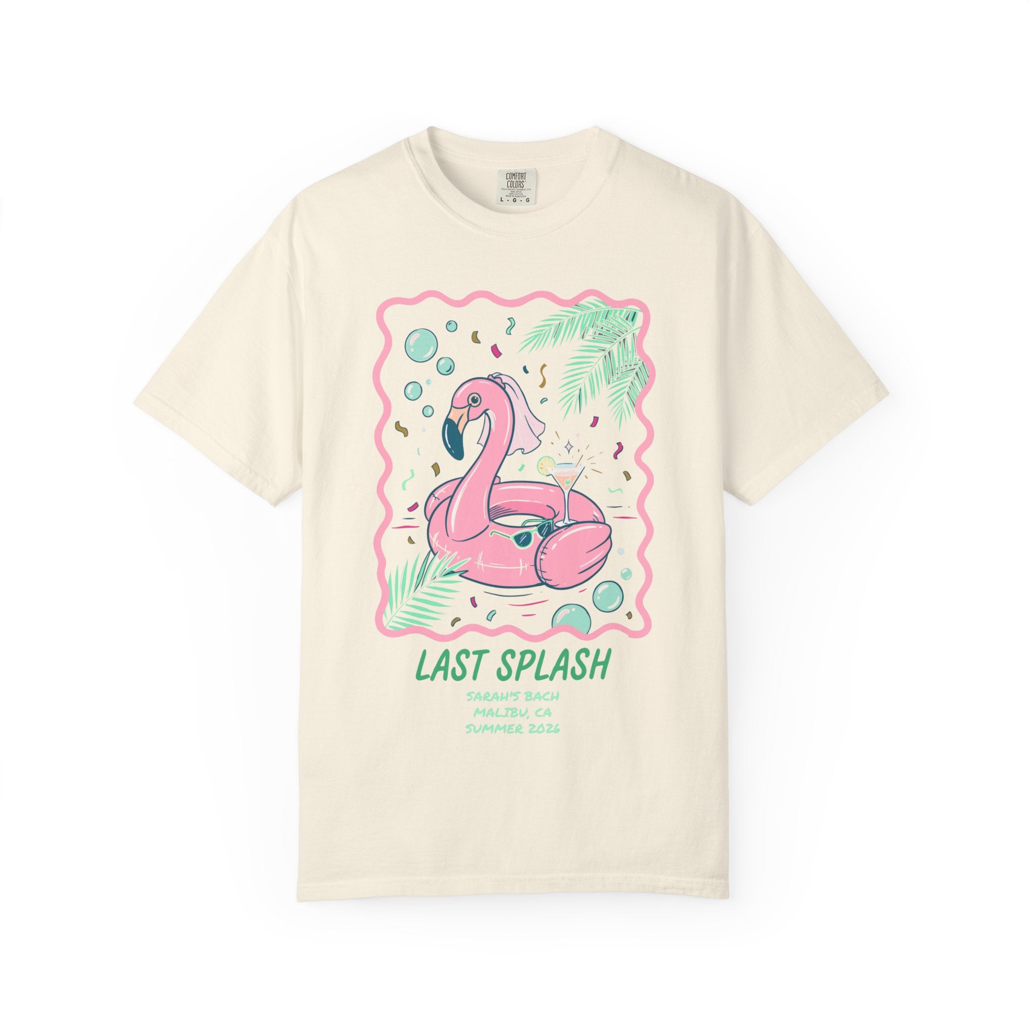 Cream t-shirt with flamingo float, cocktail, and palm leaves.