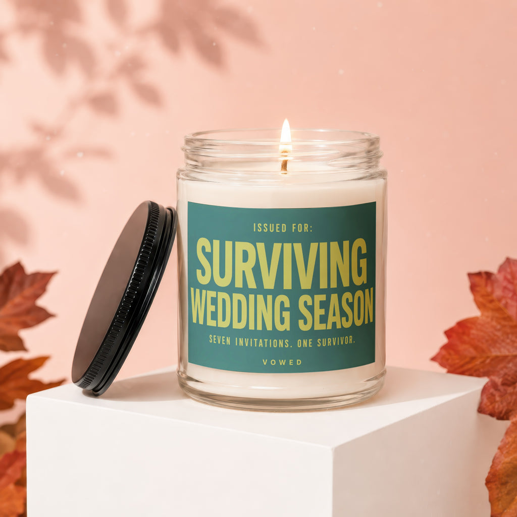 Scented candle with text "Surviving Wedding Season: Seven Invitations. One Survivor."